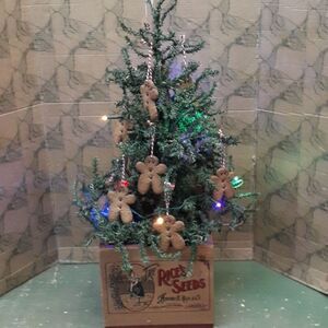 Gingerbread tree with lots of gingerbread cookie ornaments and colored lights